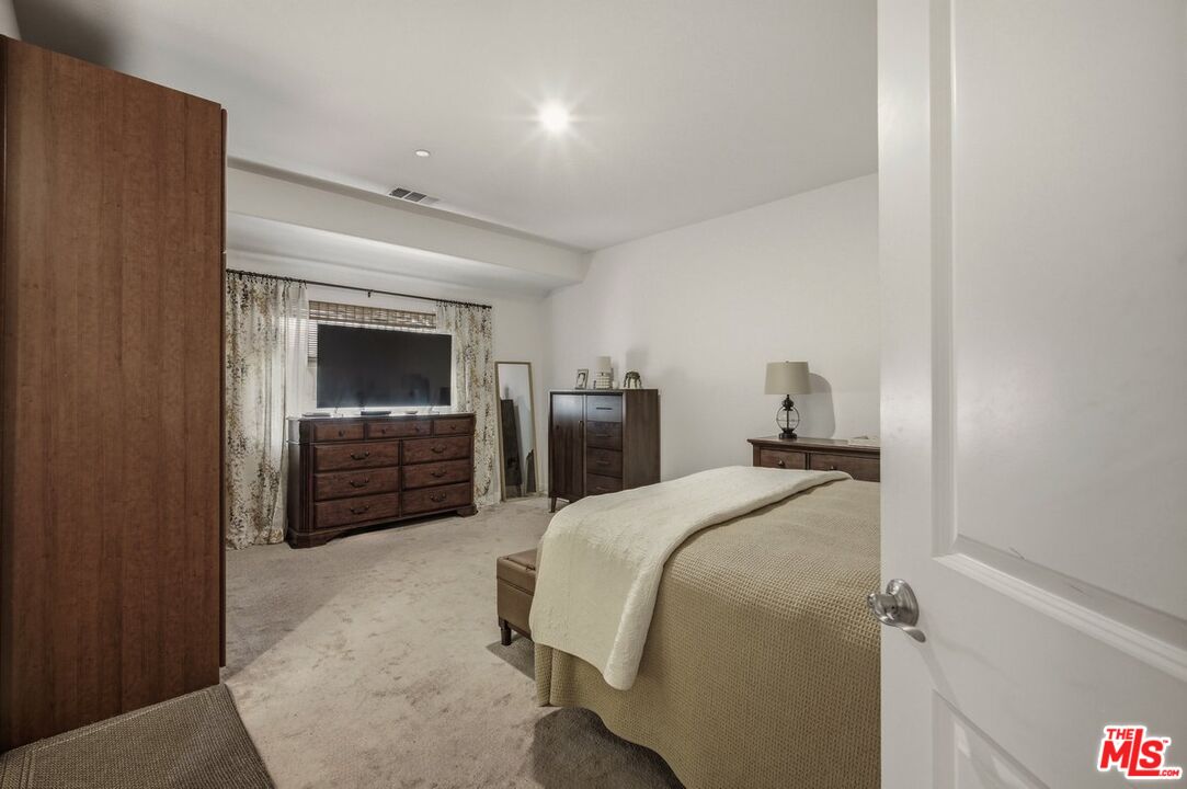 3065 Gibson Street Riverside, CA 92503 - Photo 6 of 15 a bedroom with a bed and a television