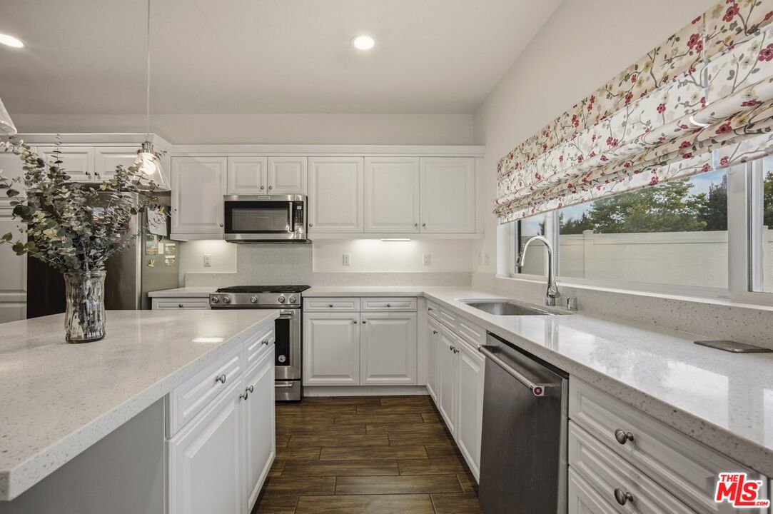 3065 Gibson Street Riverside, CA 92503 - Photo 8 of 15 a kitchen with a sink stove and microwave