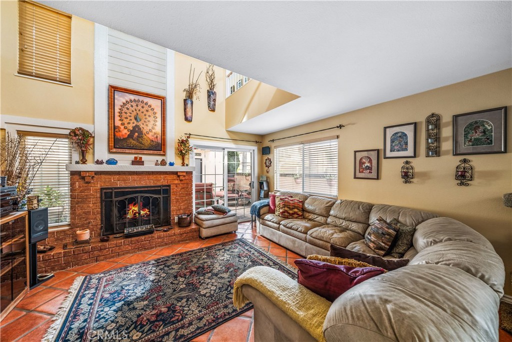 427 21st Street Huntington Beach, CA 92648 - Photo 14 of 63 a living room with furniture a window and a fireplace