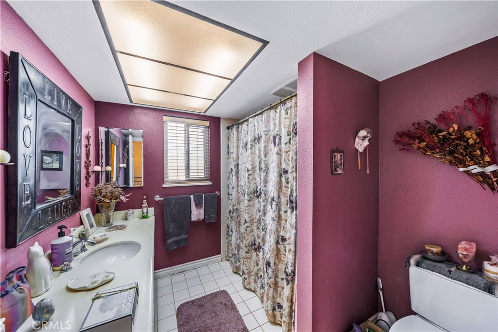 427 21st Street Huntington Beach, CA 92648 - Photo 19 of 63 a bathroom with a bathtub shower sink and mirror