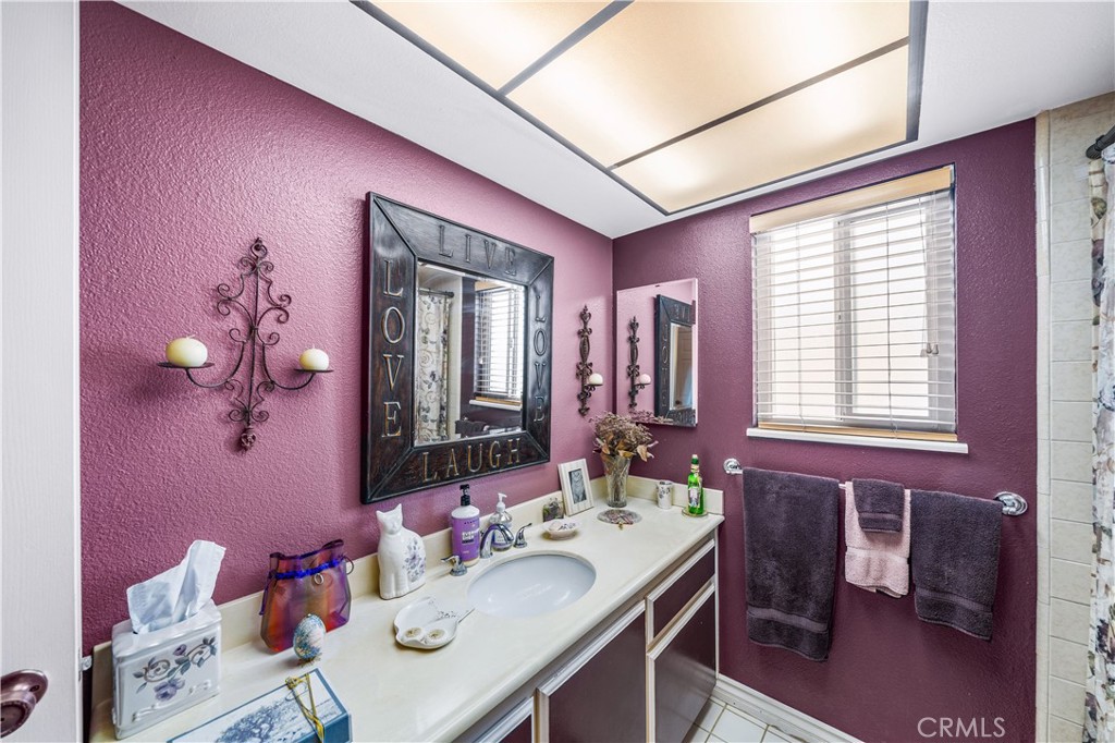 427 21st Street Huntington Beach, CA 92648 - Photo 20 of 63 a bathroom with a granite countertop sink a mirror and a bathtub