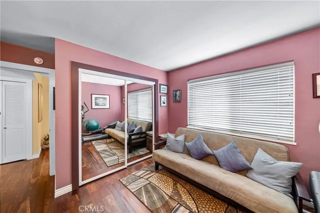 a living room with furniture and paintings on the wall