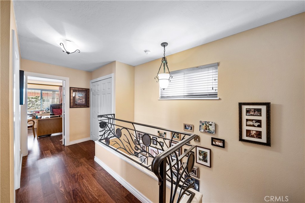 427 21st Street Huntington Beach, CA 92648 - Photo 28 of 63 a view of a hallway with wooden floor and stairs