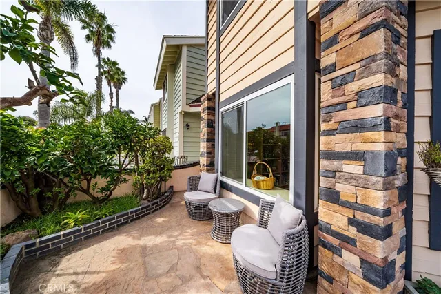 a living room with furniture kitchen view and a window