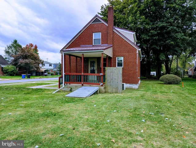 a view of a house with a yard and tree s