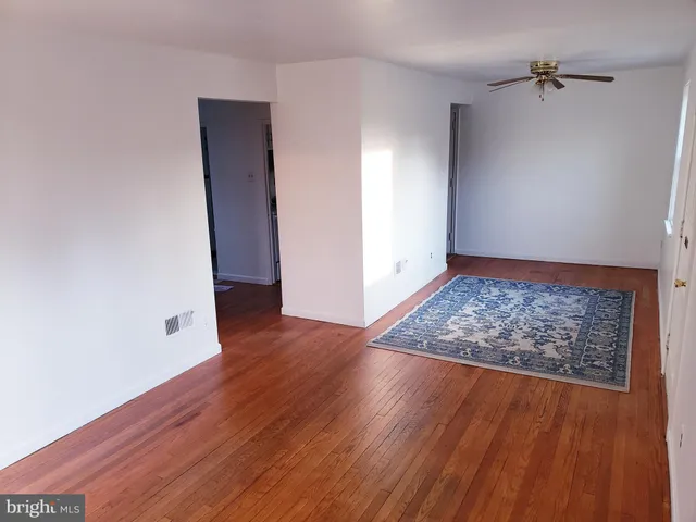an empty room with wooden floor