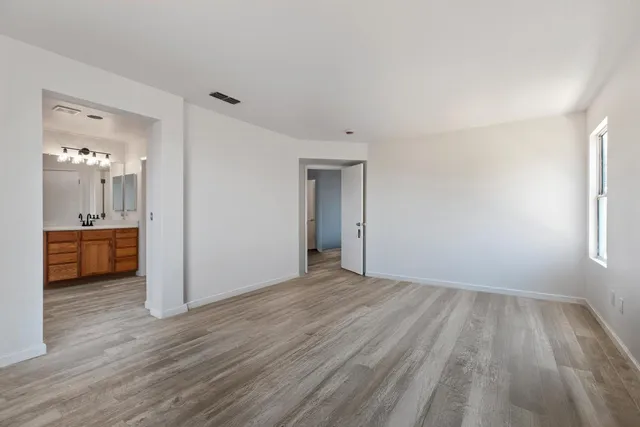 a view of a room with wooden floor and a sink