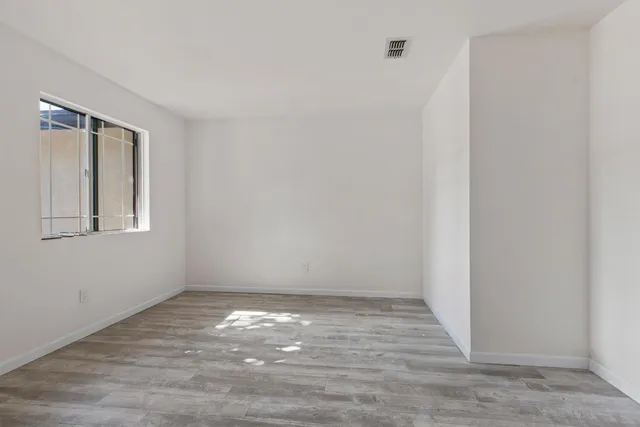 a view of room with window and hardwood floor