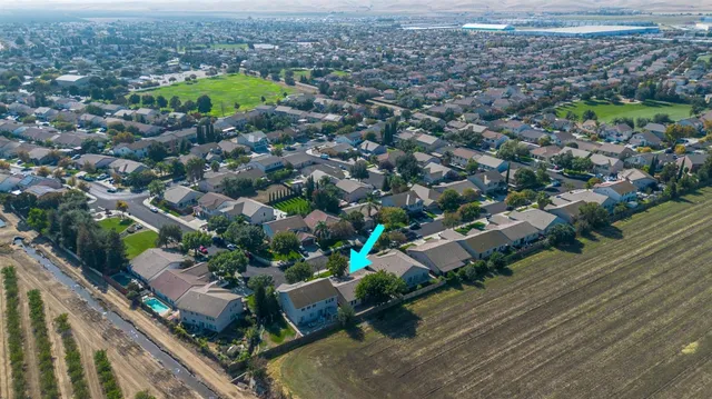 an aerial view of a houses with a yard