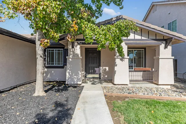 a front view of a house with garden