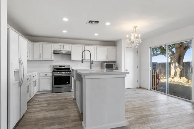 a kitchen with refrigerator and cabinets