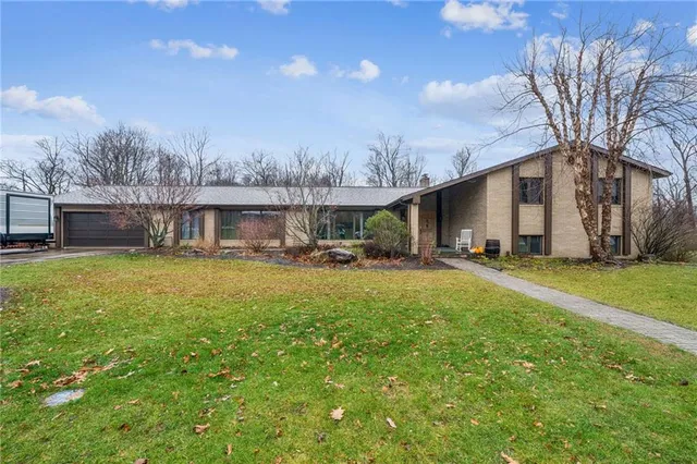 a front view of house with yard and seating area