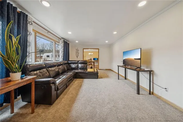 a living room with furniture gym equipment and a flat screen tv