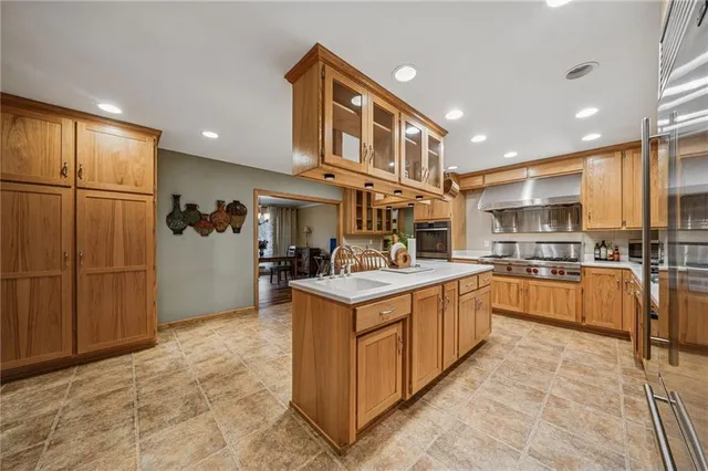 a kitchen with stainless steel appliances granite countertop a stove and a refrigerator