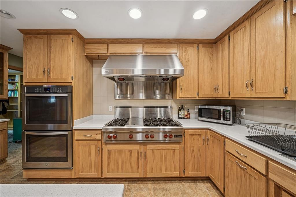 121 Mulberry Street Hopwood, PA 15445 - Photo 17 of 50 a kitchen with stainless steel appliances granite countertop a stove and a refrigerator