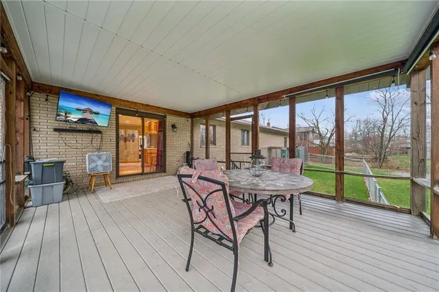 a view of balcony with wooden floor and fence