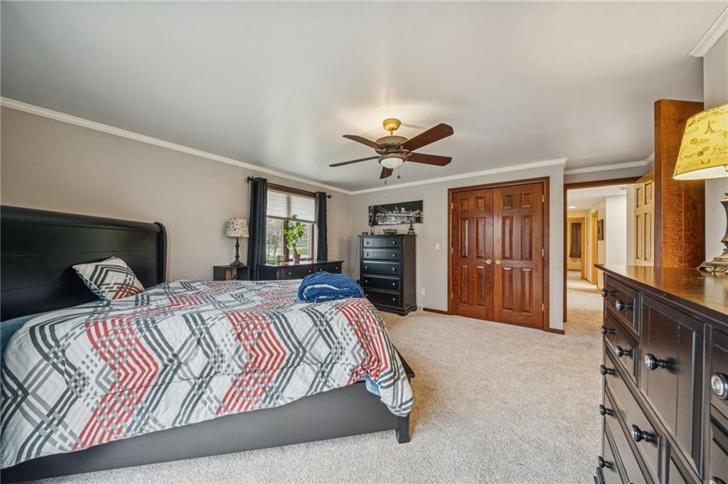 121 Mulberry Street Hopwood, PA 15445 - Photo 23 of 50 a bedroom with a large bed and a chandelier