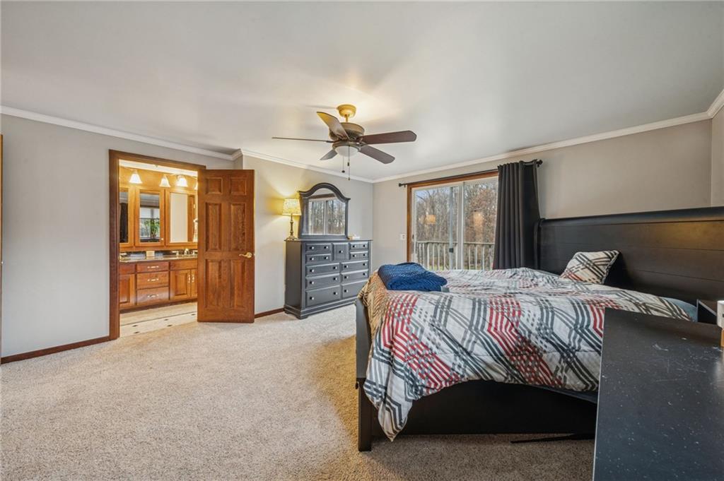 121 Mulberry Street Hopwood, PA 15445 - Photo 24 of 50 a bedroom with a bed and a chandelier