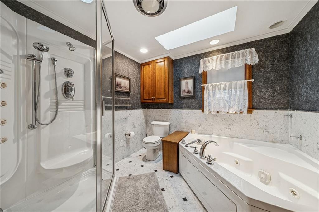 121 Mulberry Street Hopwood, PA 15445 - Photo 26 of 50 a bathroom with a bathtub a toilet and a shower