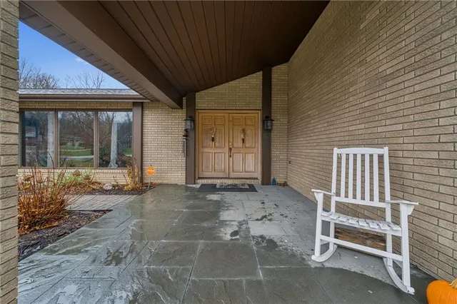 a backyard of a house with barbeque oven table and chairs