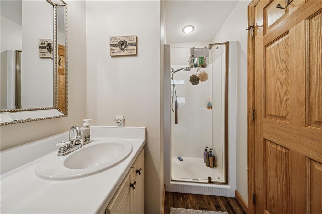 121 Mulberry Street Hopwood, PA 15445 - Photo 31 of 50 a bathroom with a sink a mirror a shower and vanity