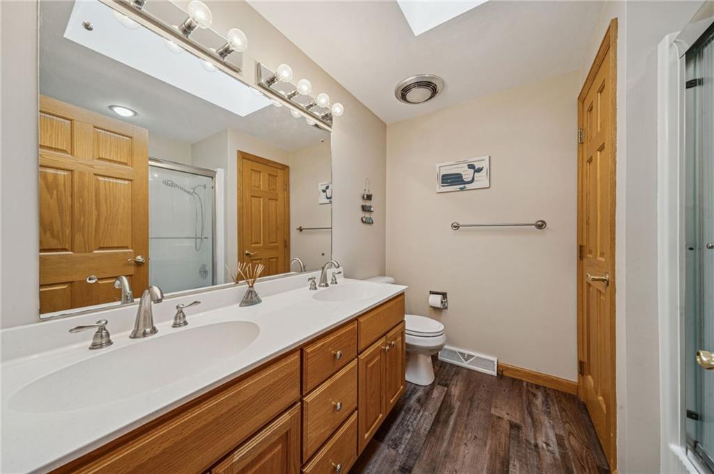 121 Mulberry Street Hopwood, PA 15445 - Photo 32 of 50 a spacious bathroom with a double vanity sink toilet and a mirror