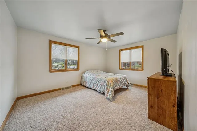 a view of an empty room with window and cabinet