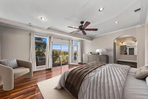 a bedroom with a large bed and a large window