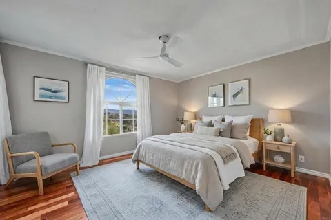 a bedroom with a bed a couch and dresser