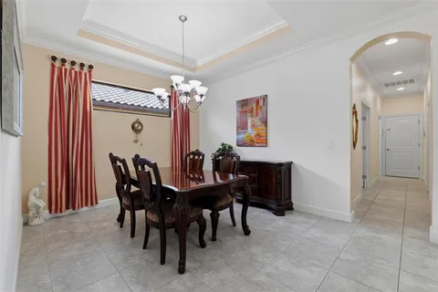a view of a dining room with furniture and chandelier