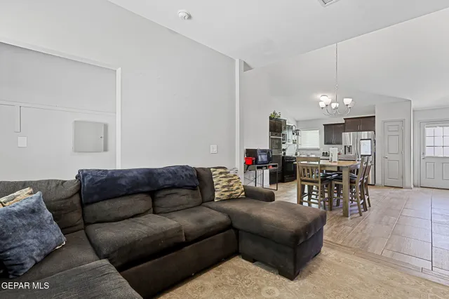 a living room with furniture and kitchen view