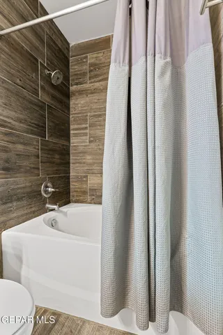 a bathroom with a bathtub and shower