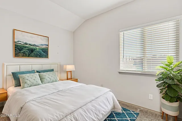 a bedroom with a bed and a potted plant