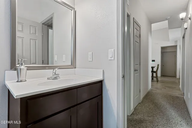 a en suite bathroom with a sink and a mirror