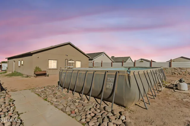 a view of a wooden house with a yard