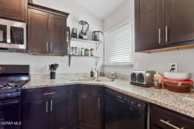 a kitchen with granite countertop lots of counter space and cabinets
