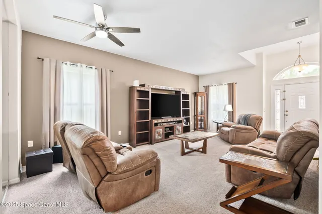 a kitchen with a sink a refrigerator and cabinets