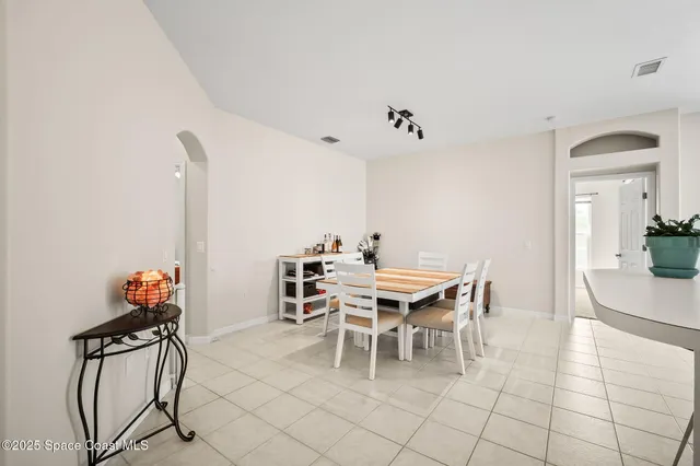 a spacious bedroom with a bed and a flat screen tv