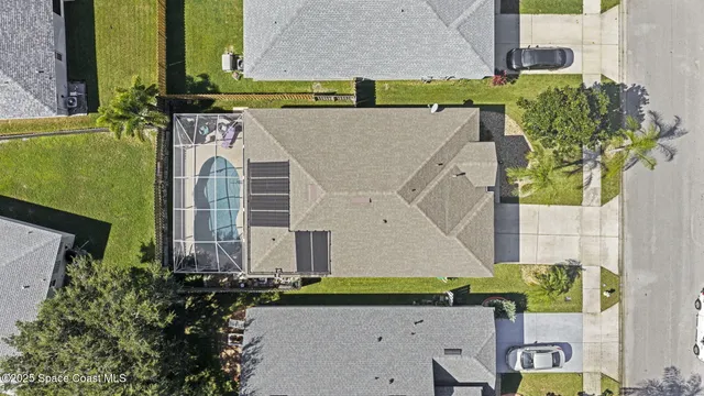 an aerial view of a house with a yard