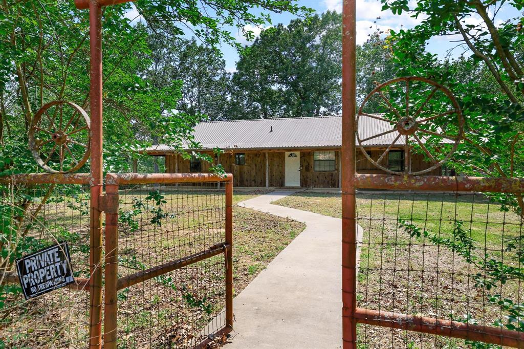 2042 East 1980 Road Antlers, OK 74523 - Photo 11 of 33 a view of a small yard in front of a house with a large tree and plants