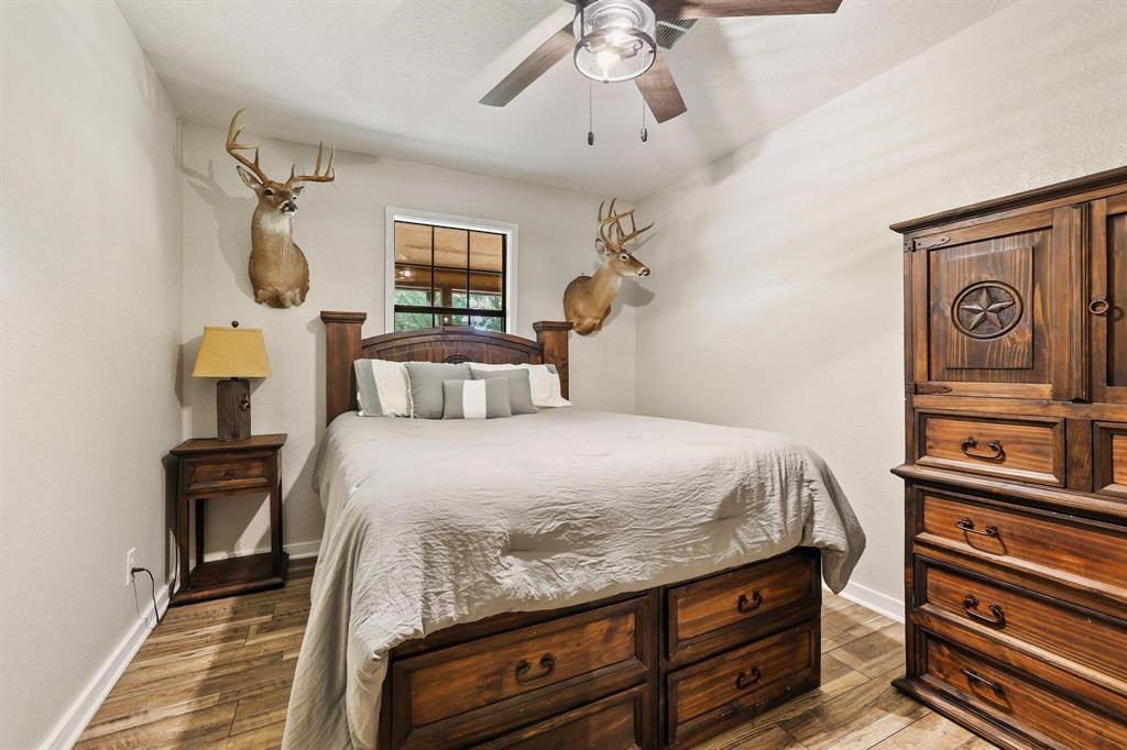 2042 East 1980 Road Antlers, OK 74523 - Photo 24 of 33 a bedroom with a bed and a chandelier