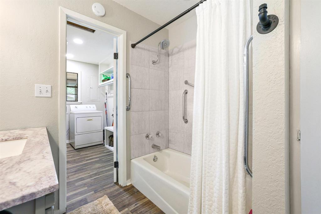 2042 East 1980 Road Antlers, OK 74523 - Photo 27 of 33 a bathroom with a tub a sink and wooden floor