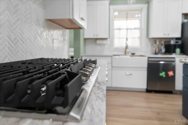 a kitchen with stove and cabinets