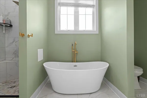 a white bath tub sitting in a bathroom