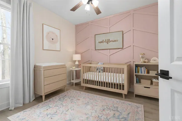 a view of a hallway to rooms and wooden floor