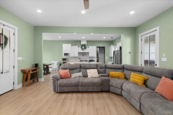 a living room with furniture and a wooden floor