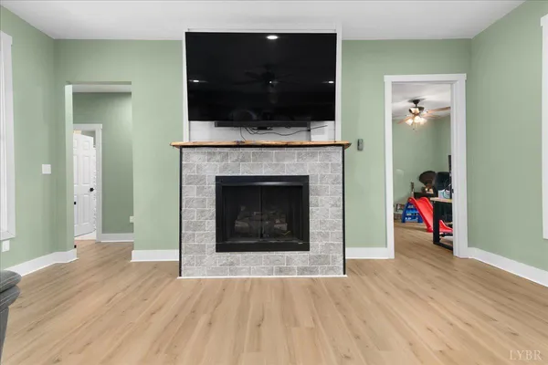 a living room with a fireplace and a flat screen tv