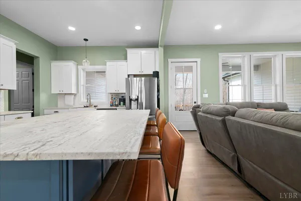 a living room with kitchen island furniture and a wooden floor