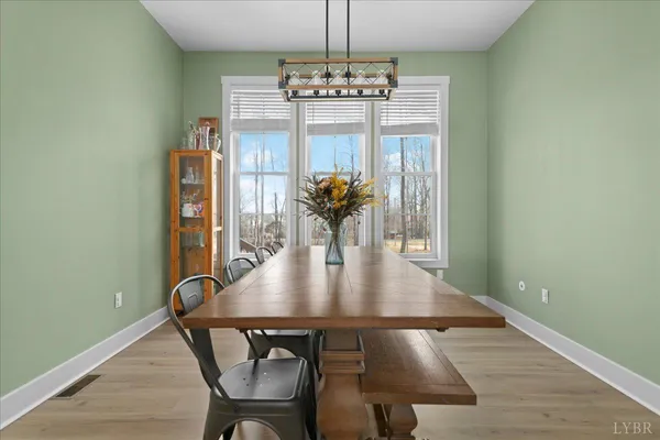 a view of a dining room with furniture wooden floor and chandelier