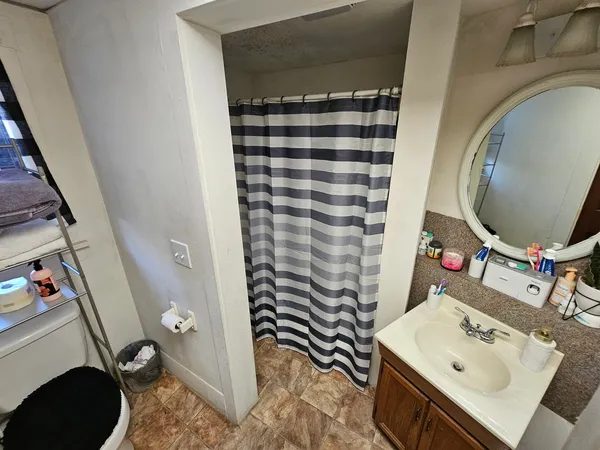 a bathroom with a sink toilet and shower